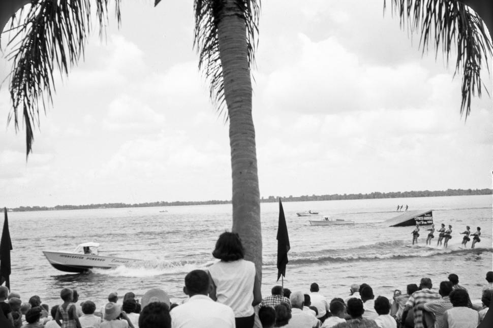 Free Image of Crowd watches waterskiing show with boats and skis 
