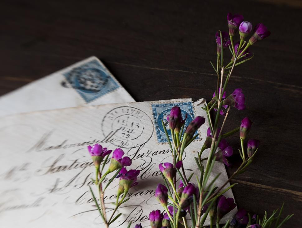 Free Image of Vintage letters with purple flowers on wooden surface. 