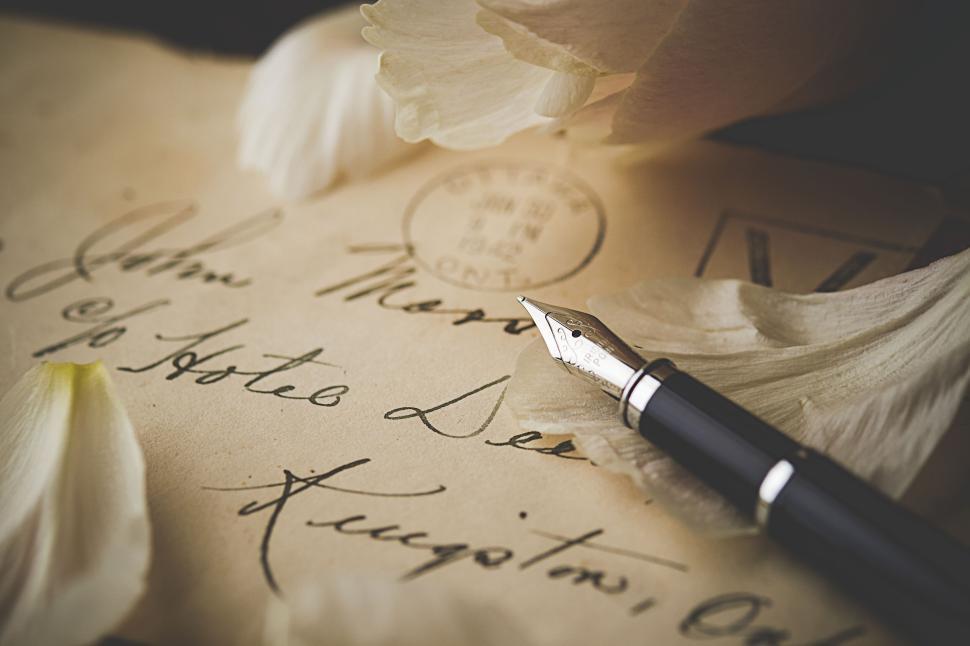 Free Image of Elegant fountain pen resting on a vintage letter envelope 