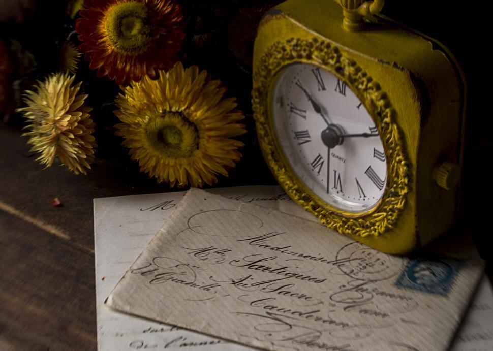 Free Image of Yellow vintage clock with letters and dried flowers 