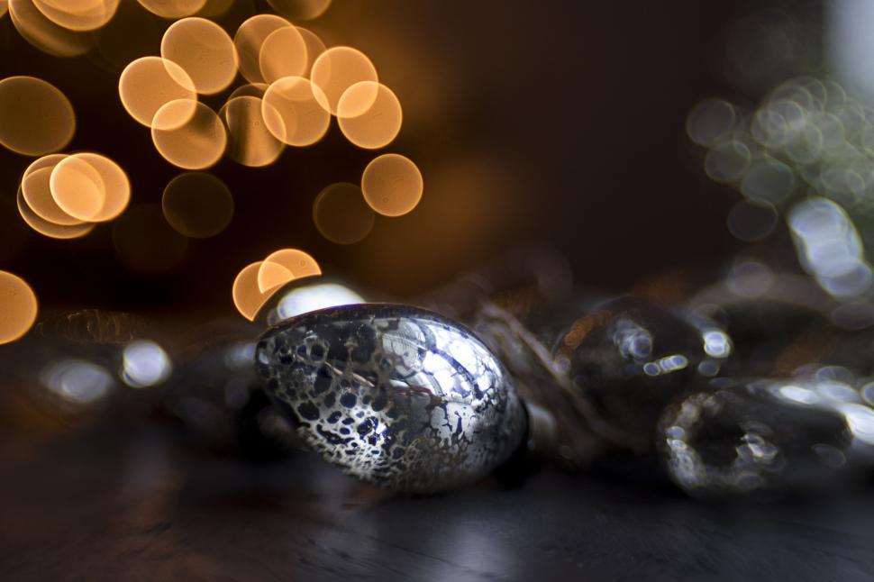 Free Image of Metallic decorations with bokeh lighting effect behind. 