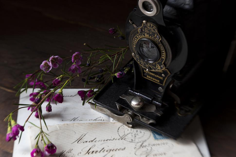Free Image of Old camera and handwritten letters with purple flowers 