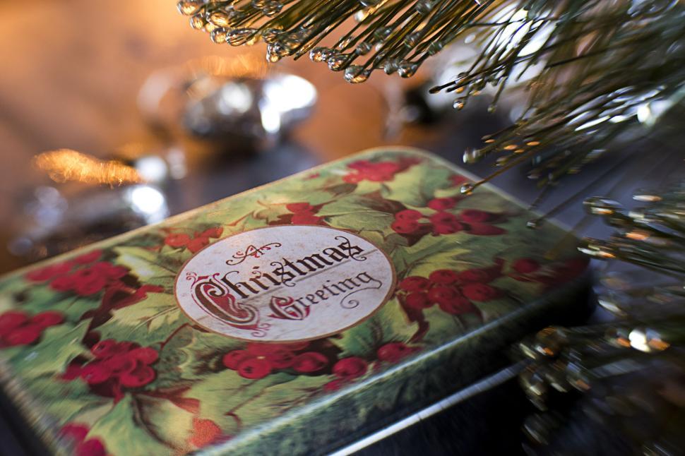 Free Image of Festive Christmas greeting tin box with holly design 