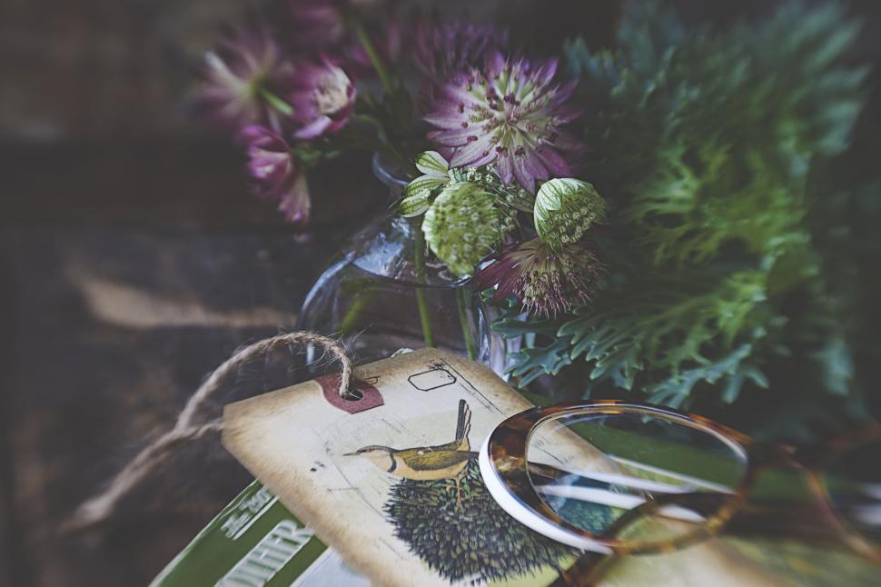 Free Image of Flower bouquet, eyeglasses, and a tag in soft focus 