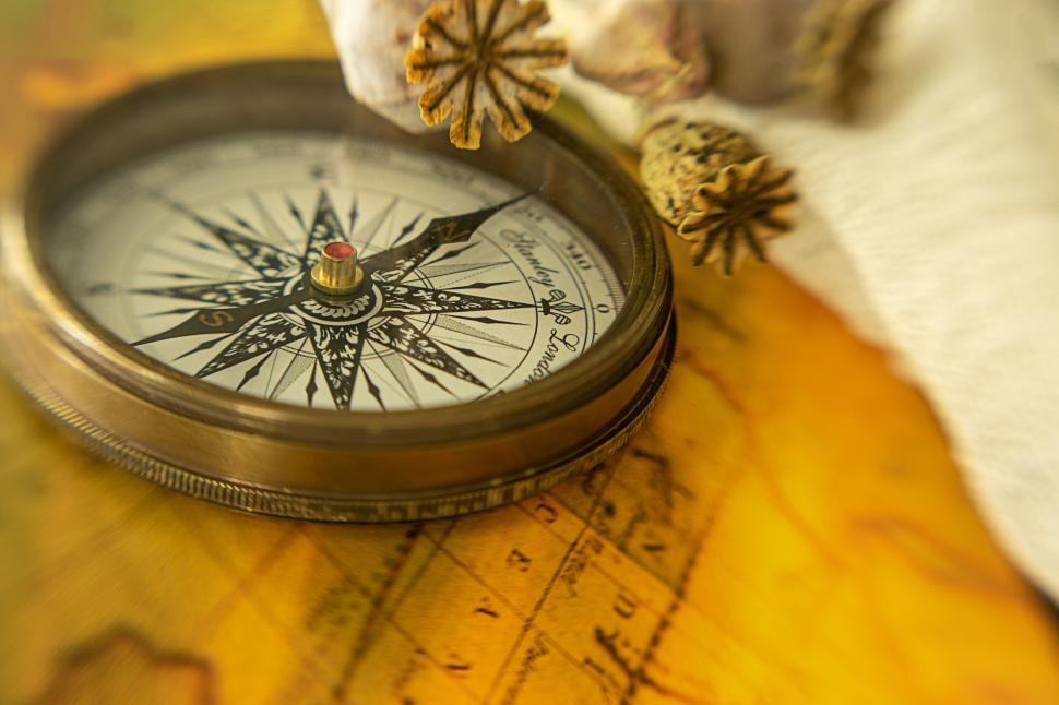 Free Image of Antique compass with star design on vintage map texture 