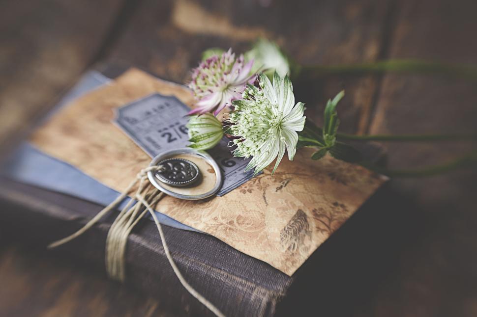 Free Image of Vintage book with floral embellishments on wooden surface 
