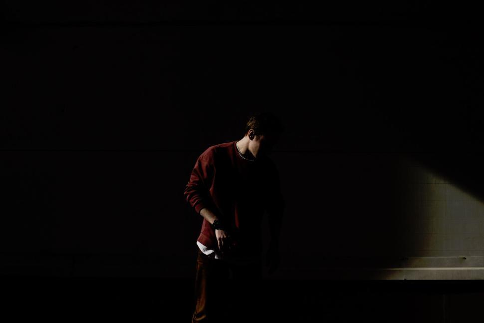 Free Image of Shadowed figure in dim light with mysterious ambiance 