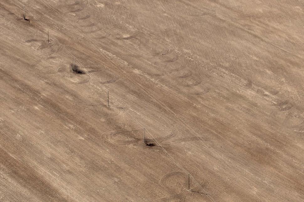Free Image of Aerial view of barren, patterned desert landscape 