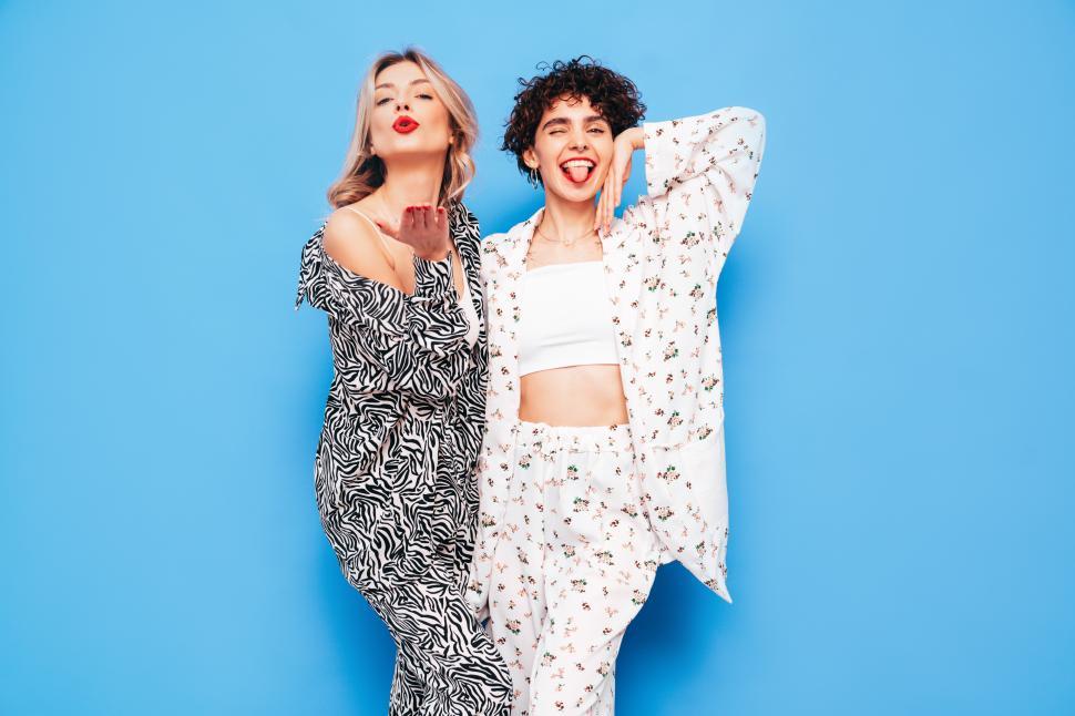 Free Image of Two women blowing kisses and sticking tongues out. 