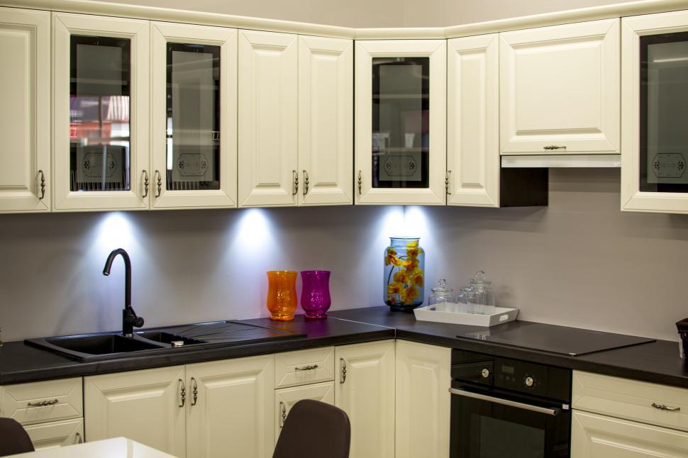 Free Image of Modern kitchen with white cabinets and colorful decor. 
