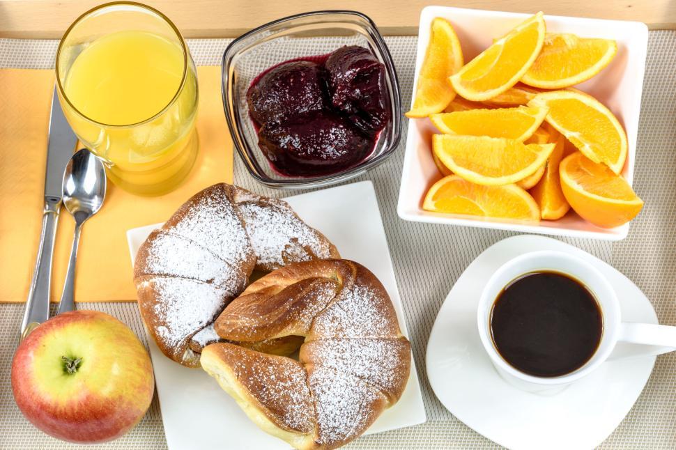 Free Image of Hearty breakfast with croissants, fruit, and coffee 