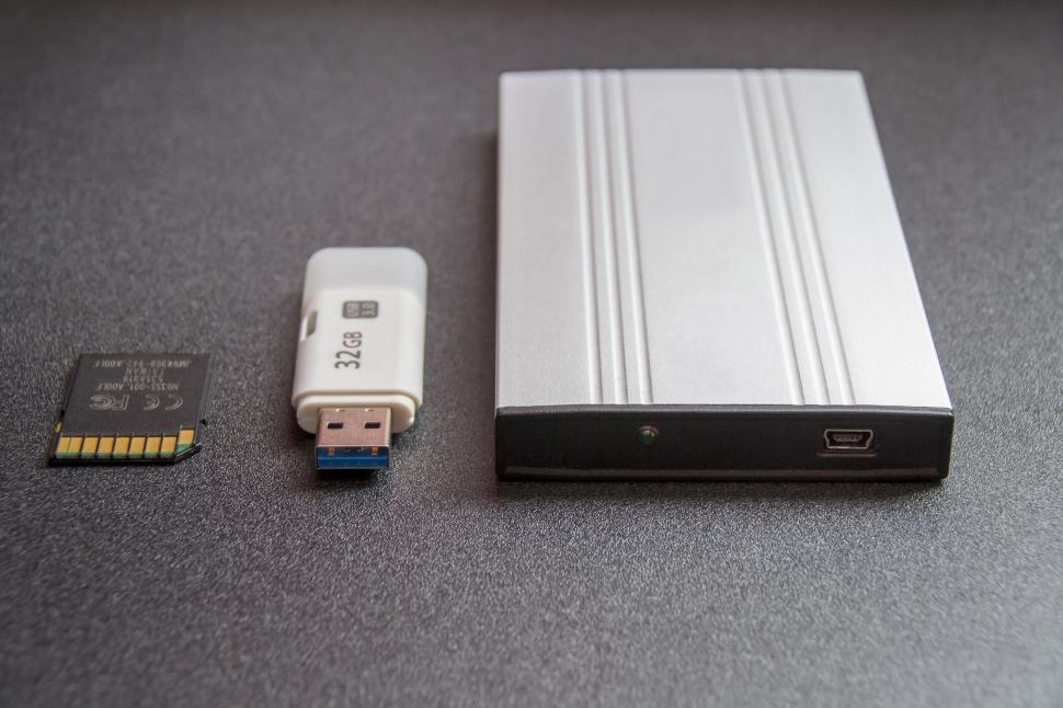 Free Image of Collection of data storage devices on a gray surface 
