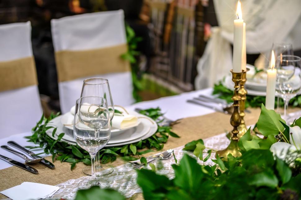 Free Image of Elegant dining table setup with candles and greenery 