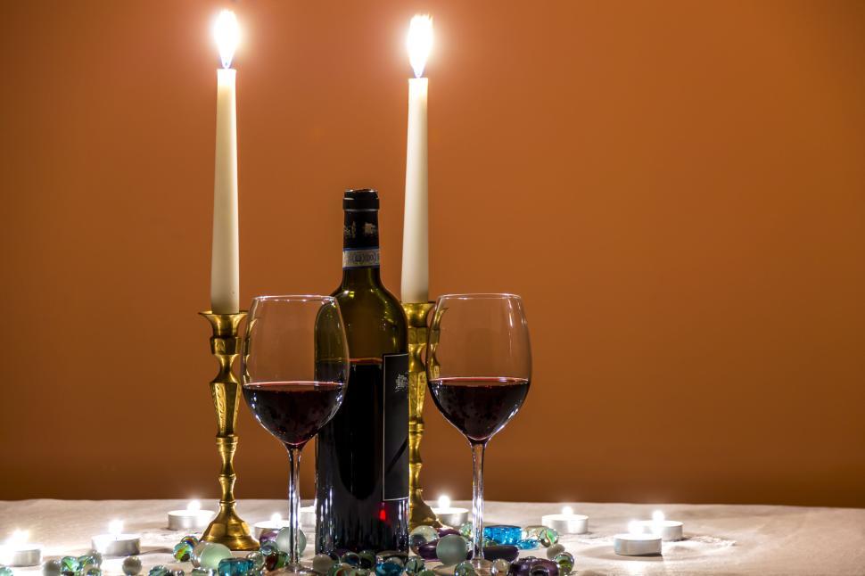 Free Image of Romantic dinner setting with wine and candles lit 