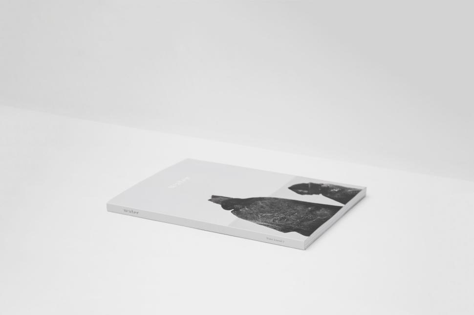 Free Image of Elegant White Booklet with Black Photography Artwork. 