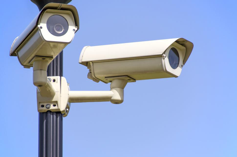 Free Image of Close-up of security cameras against a blue sky 