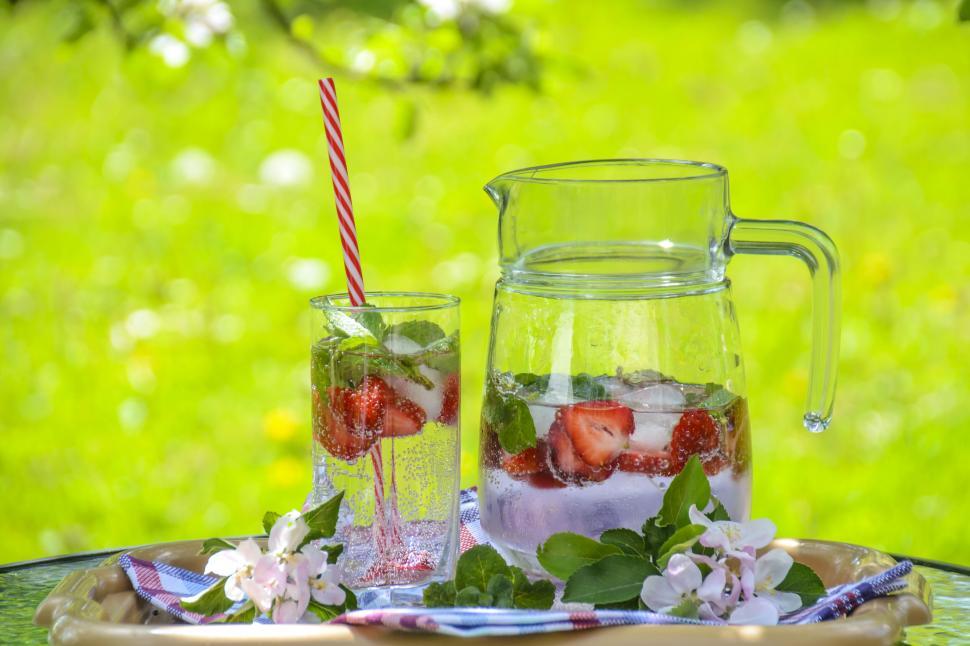 Free Image of Refreshing summer lemonade in a glass and pitcher 