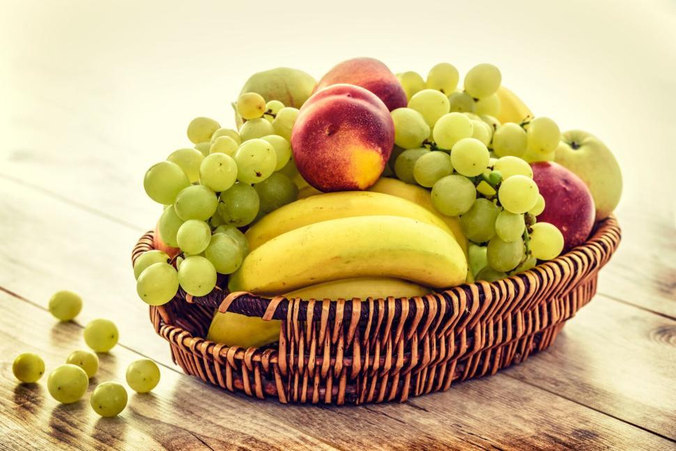 Free Image of Basket of assorted fresh fruits on a wooden table 
