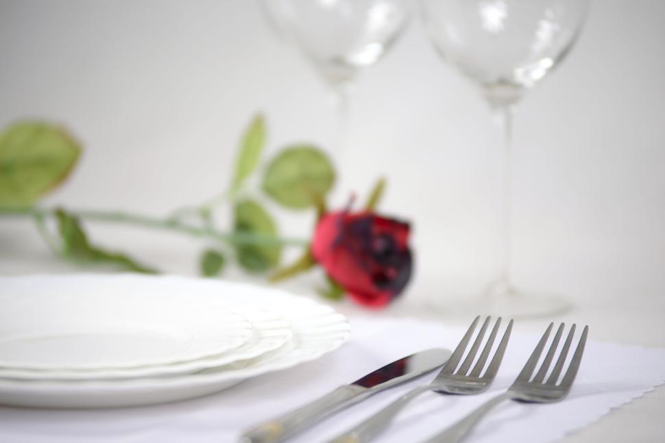 Free Image of Elegant table setting with rose and wine glasses 