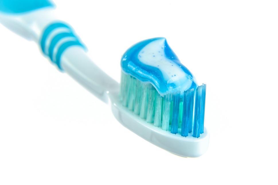 Free Image of Blue and white toothbrush with toothpaste close-up 