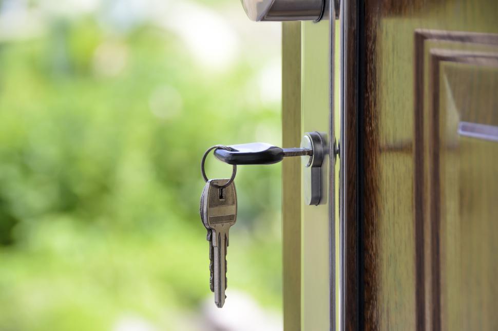 Free Image of Close-up of keys inserted in the door lock, outdoors. 