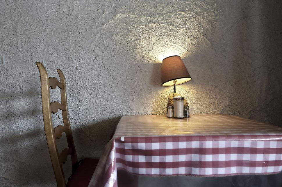 Free Image of Empty table with checked tablecloth in quiet room. 