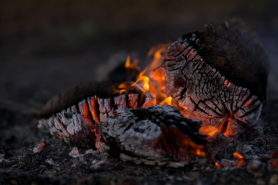 Free Image of Close-up of glowing embers in a campfire at night. 
