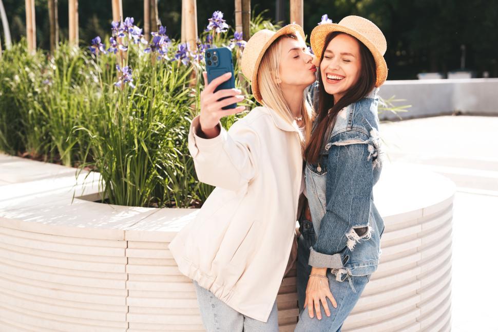 Free Image of Selfie kiss self portrait with two happy young women 