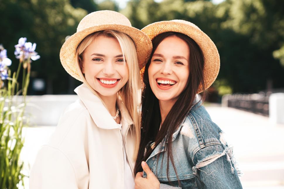 Free Image of Portrait of two attractive young women in hats 