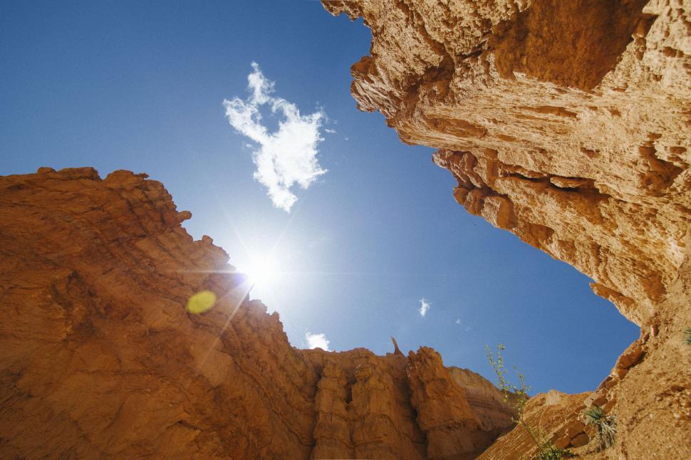 Free Image of Canyon view with clear blue sky and bright sun 