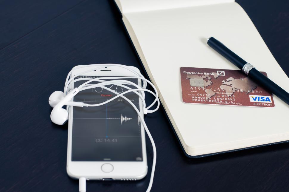 Free Image of Notebook, smartphone, credit card, and headphones on desk 