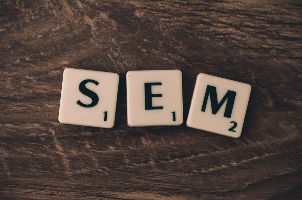 Free Image of SEM spelled out with Scrabble tiles on a wooden surface. 