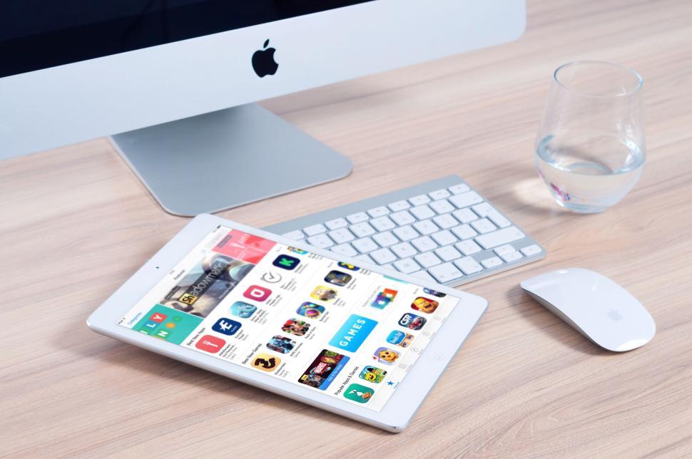 Free Image of Tablet and keyboard with glass and mouse on wooden desk. 