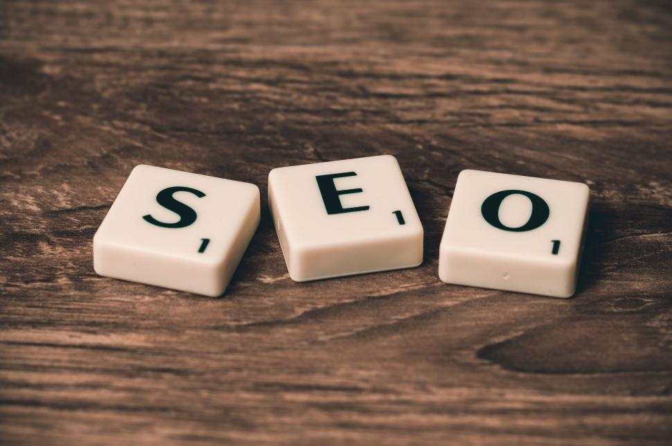 Free Image of SEO concept represented using letter tiles on wooden surface. 