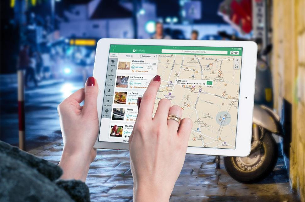 Free Image of Person using tablet device with map application open. 