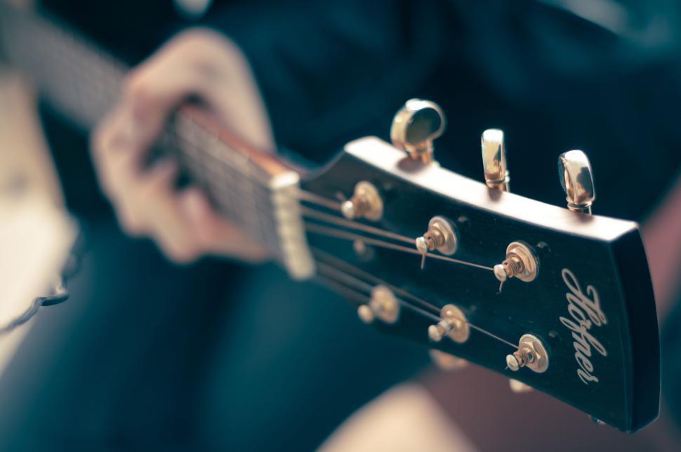 Free Image of Close-up of acoustic guitar neck and tuning pegs. 