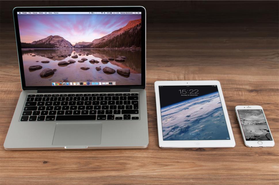 Free Image of Apple laptop, iPad, and iPhone on a wooden surface 