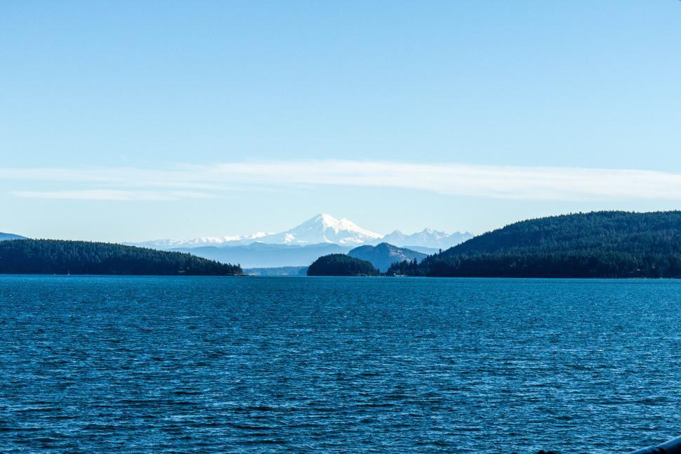 Free Image of Mountains and islands in the distance above the vast blue sea. 