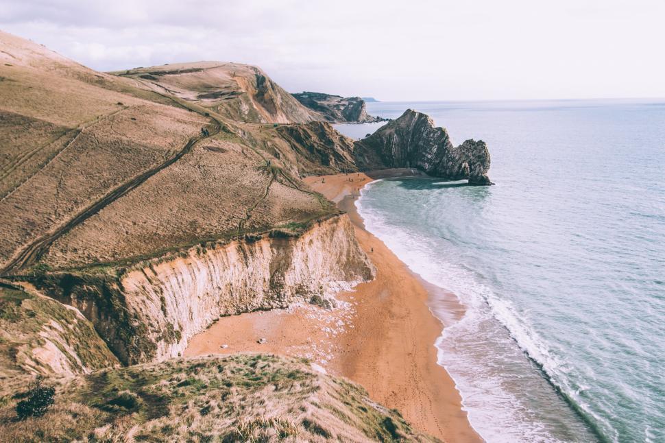 Free Image of Coastal landscape with unique rock formations by sea. 