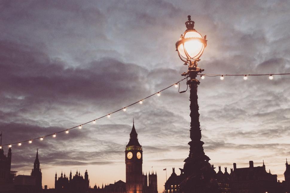 Free Image of Streetlamp and clock tower silhouette at twilight 