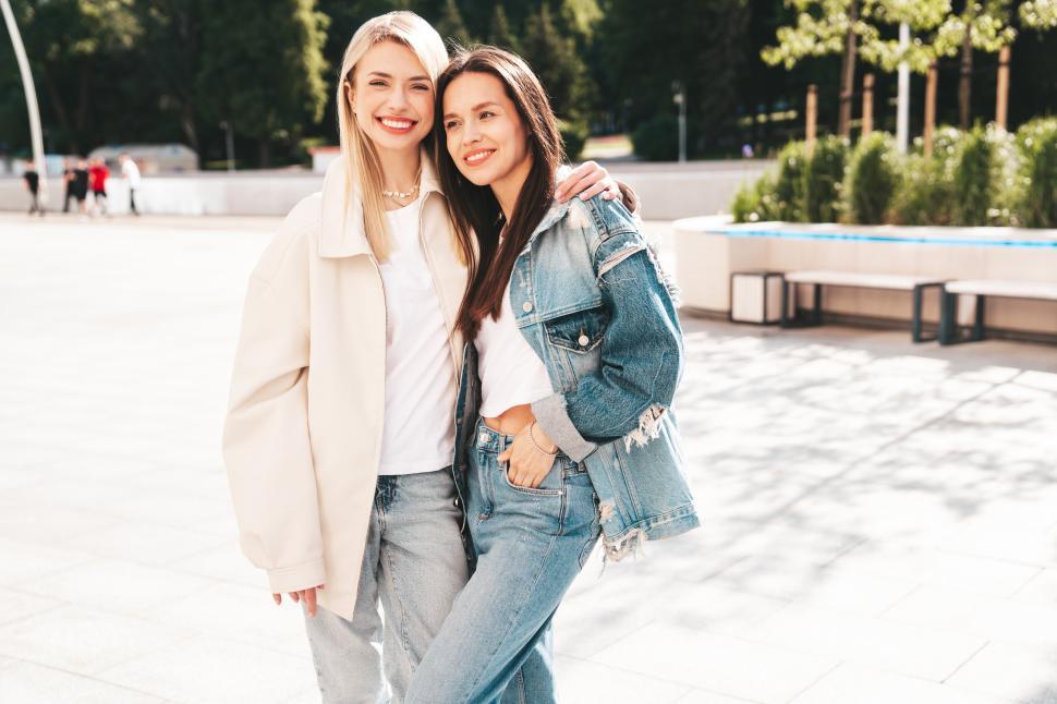 Free Image of Two women pose together in the street 