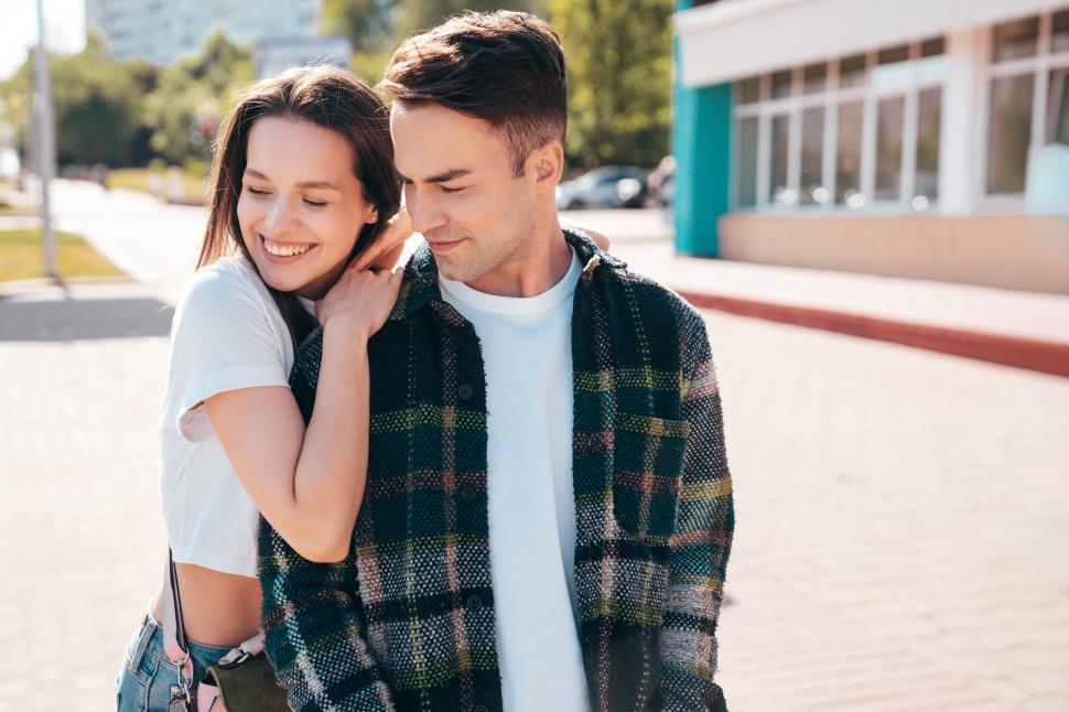 Free Image of Young couple stand together outside a building 