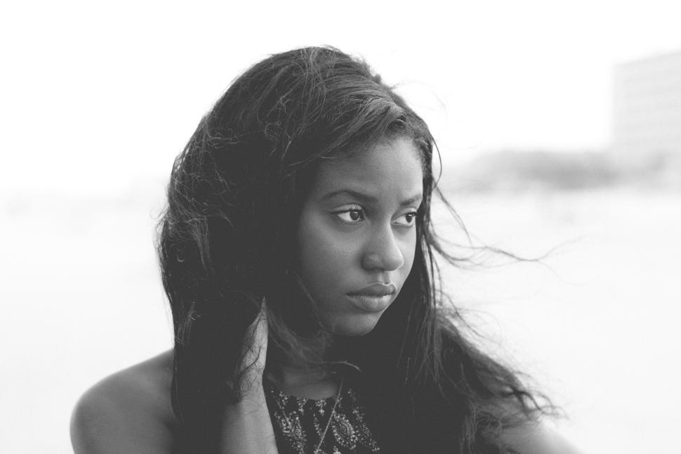 Free Image of Woman with long hair looking pensively into the distance 