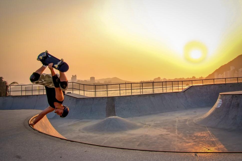 Free Image of Sunset skateboard trick at urban skate park ramp 