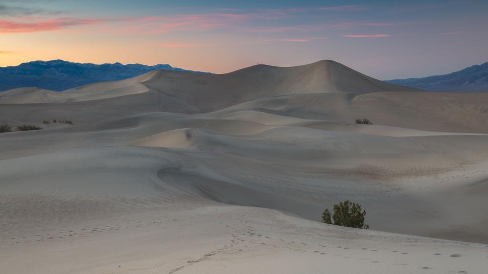 Free Image of Serene desert dunes landscape under colorful twilight sky 
