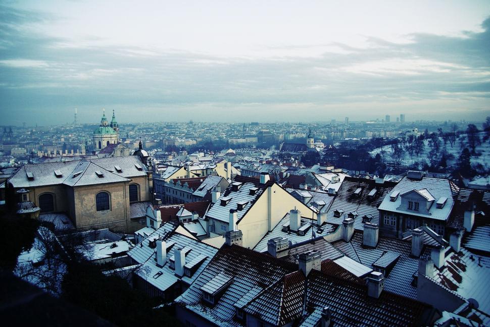 Free Image of Snow-covered rooftops in a historic European cityscape 