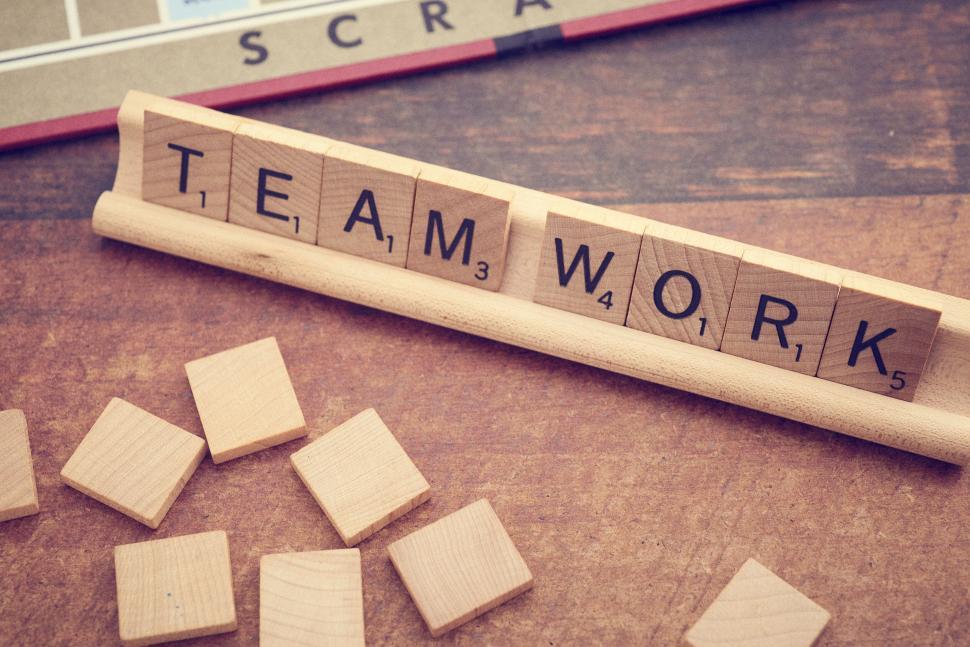 Free Image of Scrabble tiles forming the word  Teamwork  on a stand 