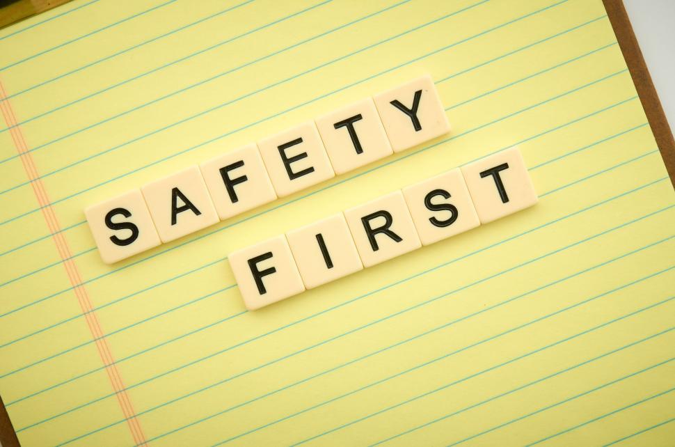 Free Image of Safety First spelled out with tiles on a yellow notepad 