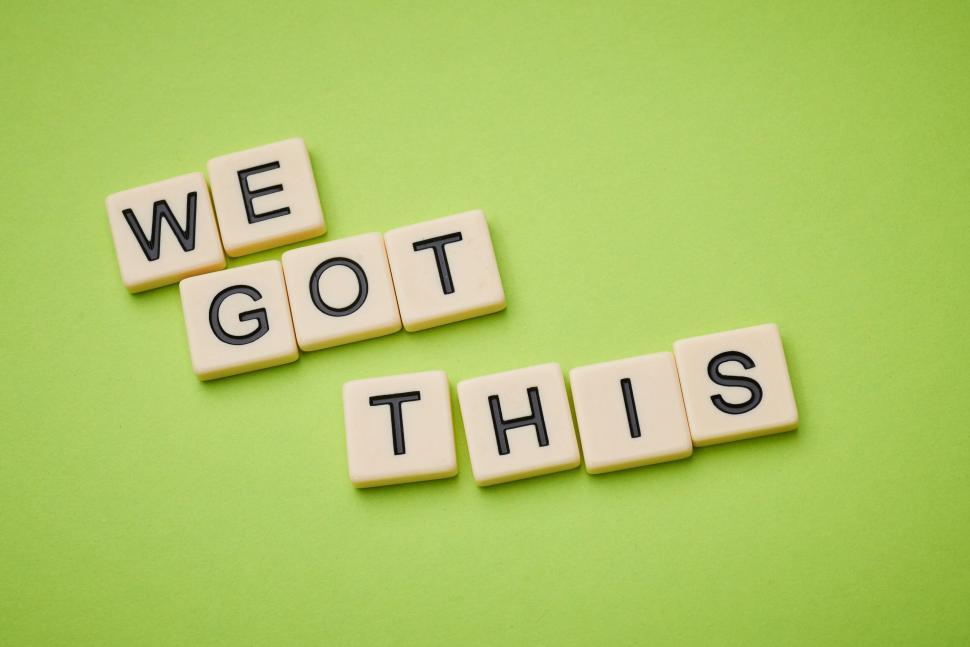 Free Image of We Got This phrase spelled out with letter tiles on green 