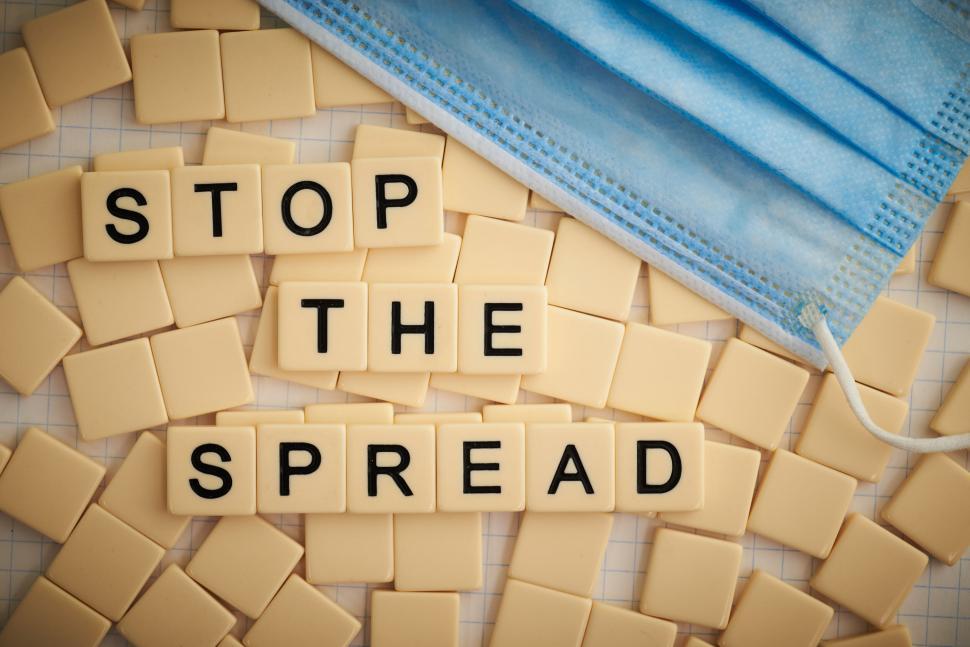 Free Image of Tiles saying  STOP THE SPREAD  with face mask present 